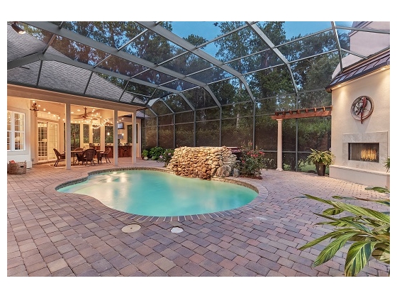 Covered lanai with pool, spa, fireplace & kitchen